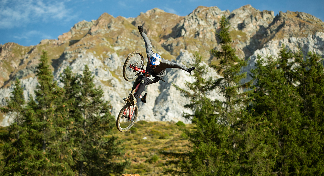 A person does a trick on the bike in the air.