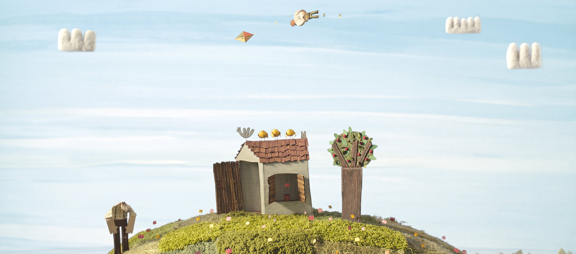 Scene of a boy flying over a small house like a kite as a man on the ground watches, from the animated film The Kite