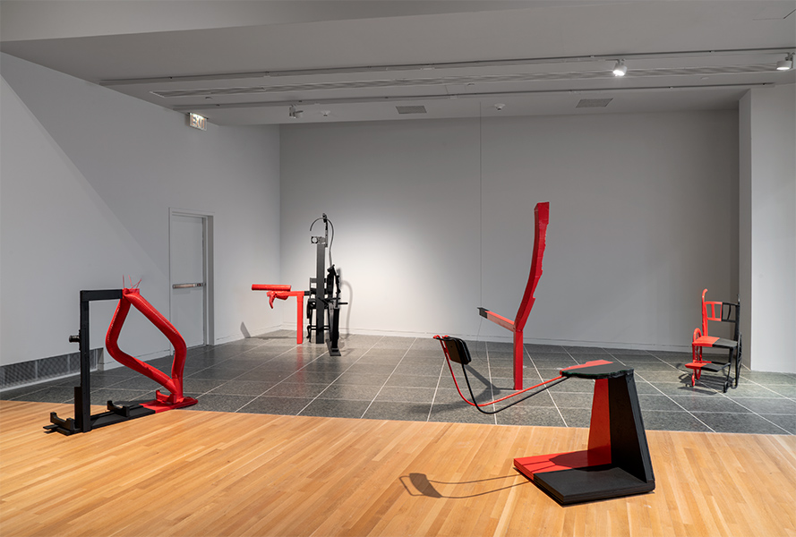Five sculptures are spread out on a gallery floor.