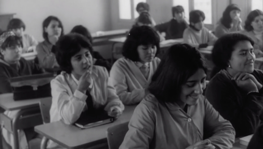 A black and white image of teenage school girls in a classroom from the documentary Elles