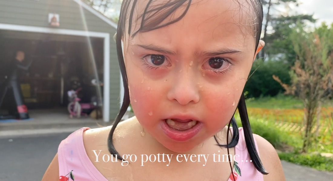 A color close-up of an upset toddler in a bathing suit with wet face and hair; a subtitle reads "You go potty every time..."