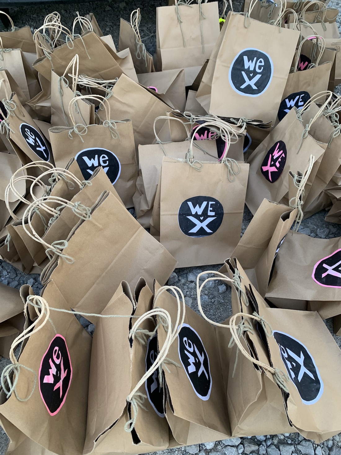 Dozens of brown paper shopping bags with circular Wex stickers