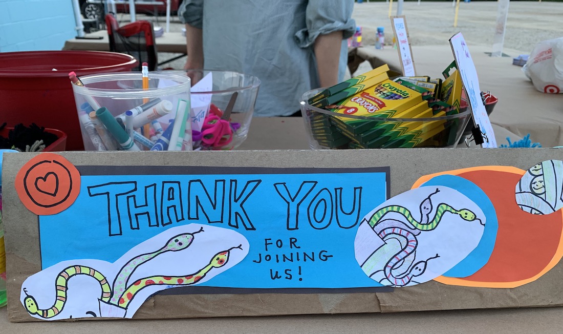 Handmade sign with drawn snake decorations that reads "thank you for joining us"