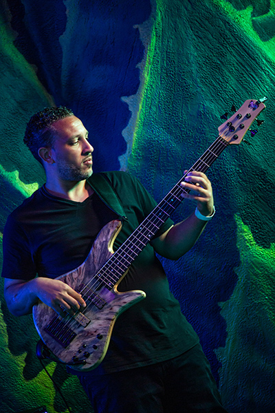 A person in a black shirt playing bass