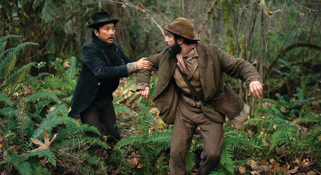 Two men in a forest in the midst of a confrontation