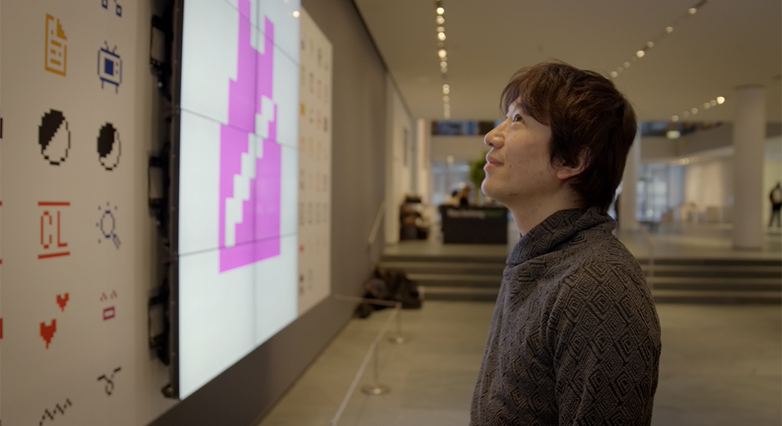 The Japanese inventor of emoji for DoCoMo, Shigetaka Kurita, admires his original designs on exhibit after they were collected by New York City’s Museum of Modern Art. 