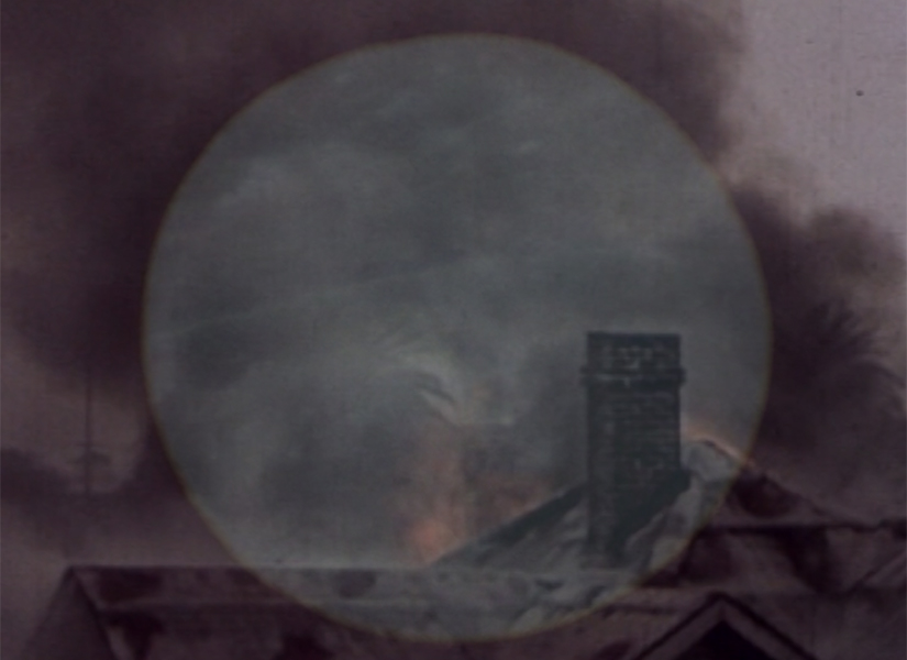 A full moon overlaid over an image of chimney and rooftop
