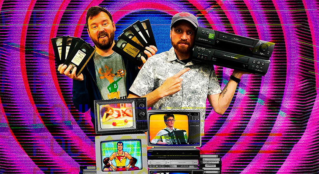 A bearded man holds three VHS tapes in each hand and next to him is a man in ball cap holding a VCR, below them are three televisions