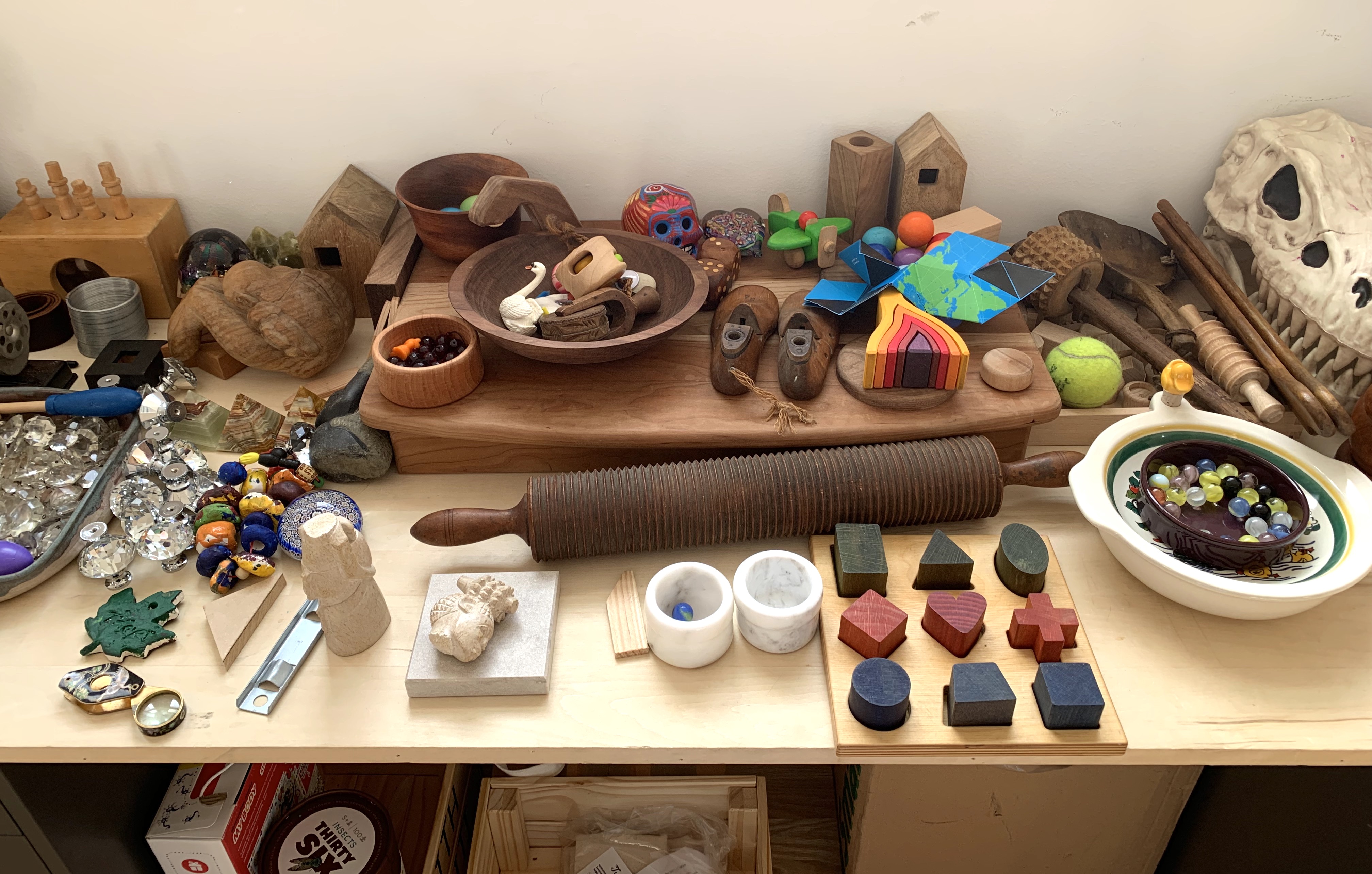 Toys and miscellaneous small items on a table in artist Jonna Twigg's studio