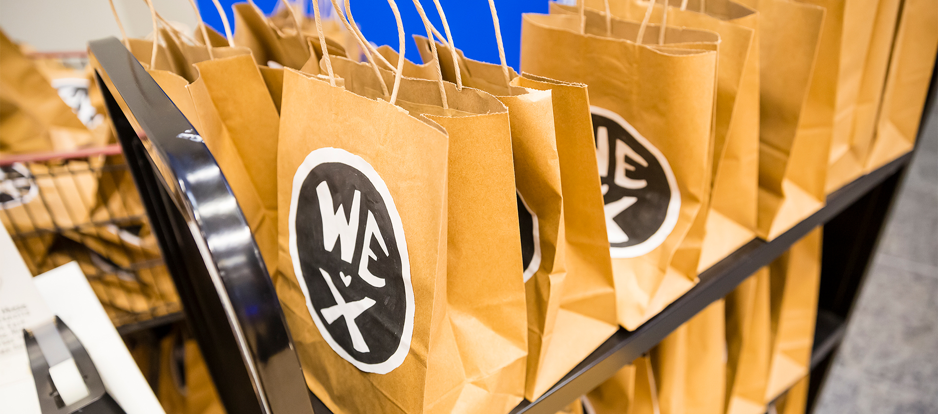 A cart of paper activity bags with a hand-drawn Wex logo await families at the center