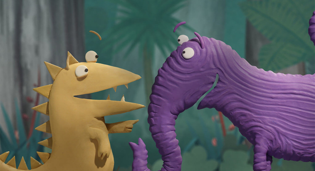 A yellow dinosaur-like creature converses with a purple elephant-like creature in this still that appears to be from a stop-motion claymation film