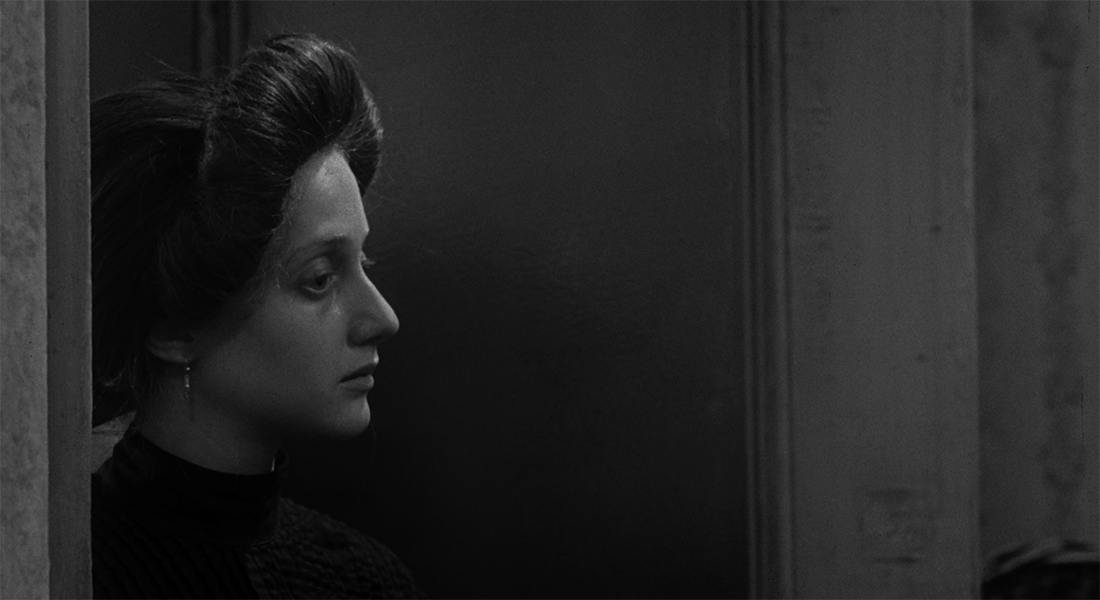 A stark image of a woman in profile, who appears sad. 