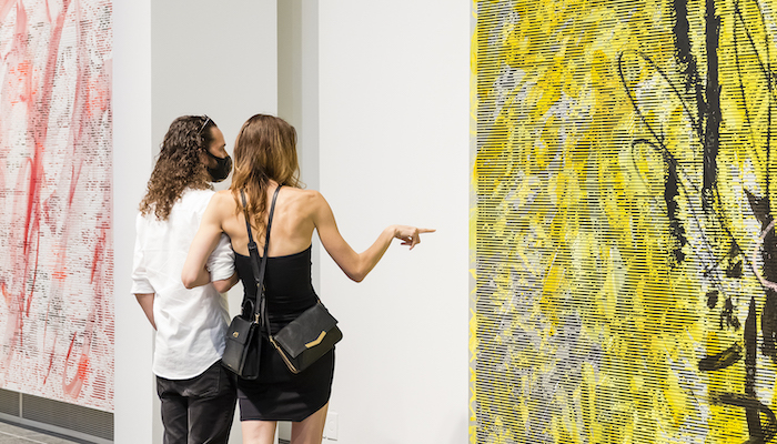 Two patrons look at a work by Jacqueline Humphries in the Wexner Center for the Arts galleries