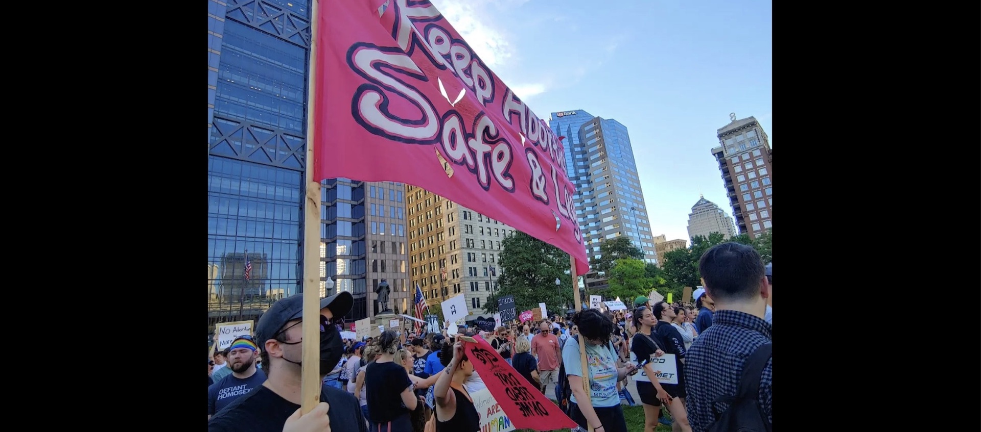 Protesters hold a banner up outside the Ohio Statehouse on the day the Supreme Court reversed the Roe v. Wade decision, June 24, 2022