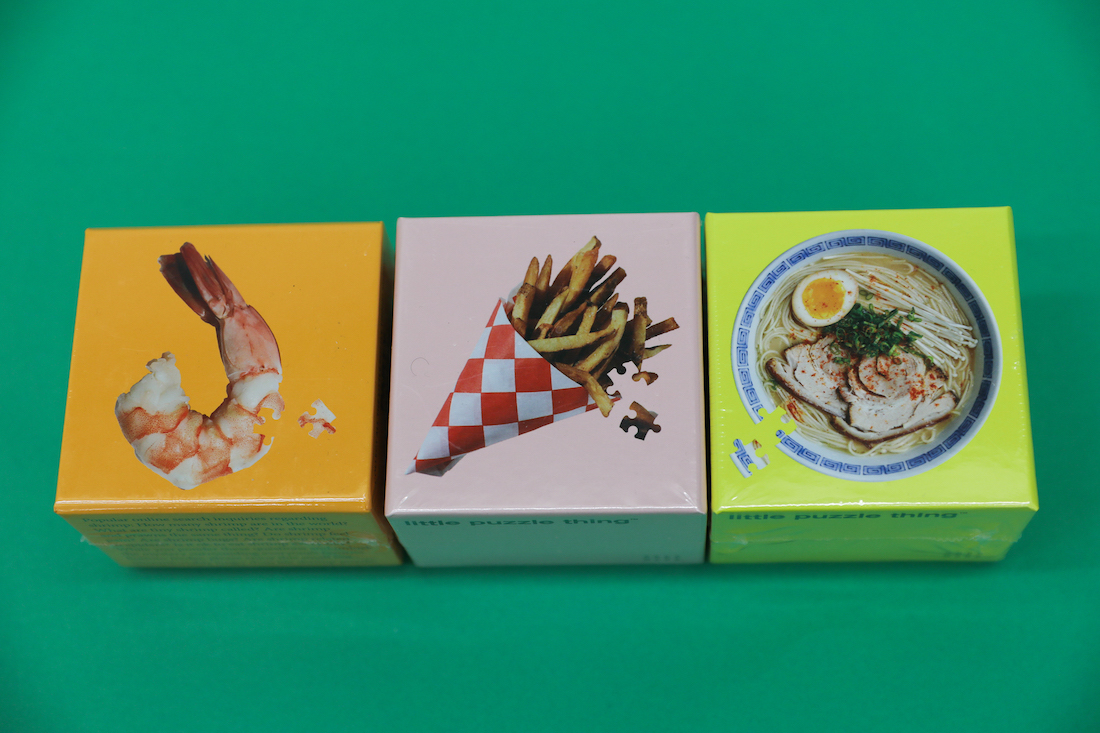 Three Little Puzzle Boxes side by side. The box covers reflect the completed puzzle pictures: a shrimp, a cone of french fries, and a bowl of ramen