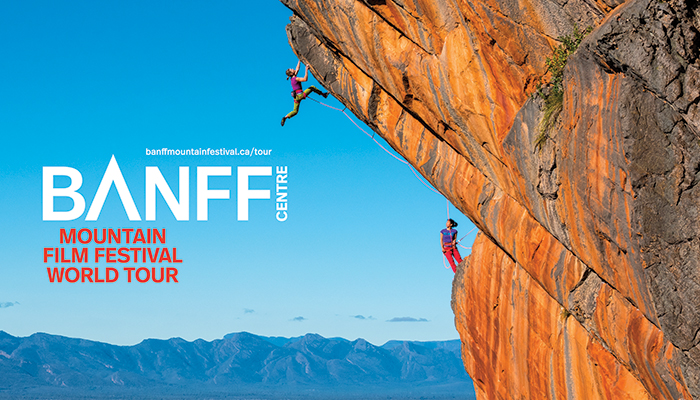 The side of mountain with two climbers scaling up all set to the backdrop of a bright blue sky with the logo for the BANFF festival overlaid