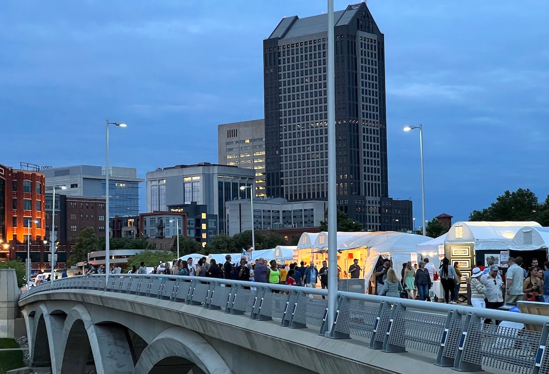 Vendors and visitors at the Columbus Arts Festival fill the Rich Street Bridge as nighttime approaches.