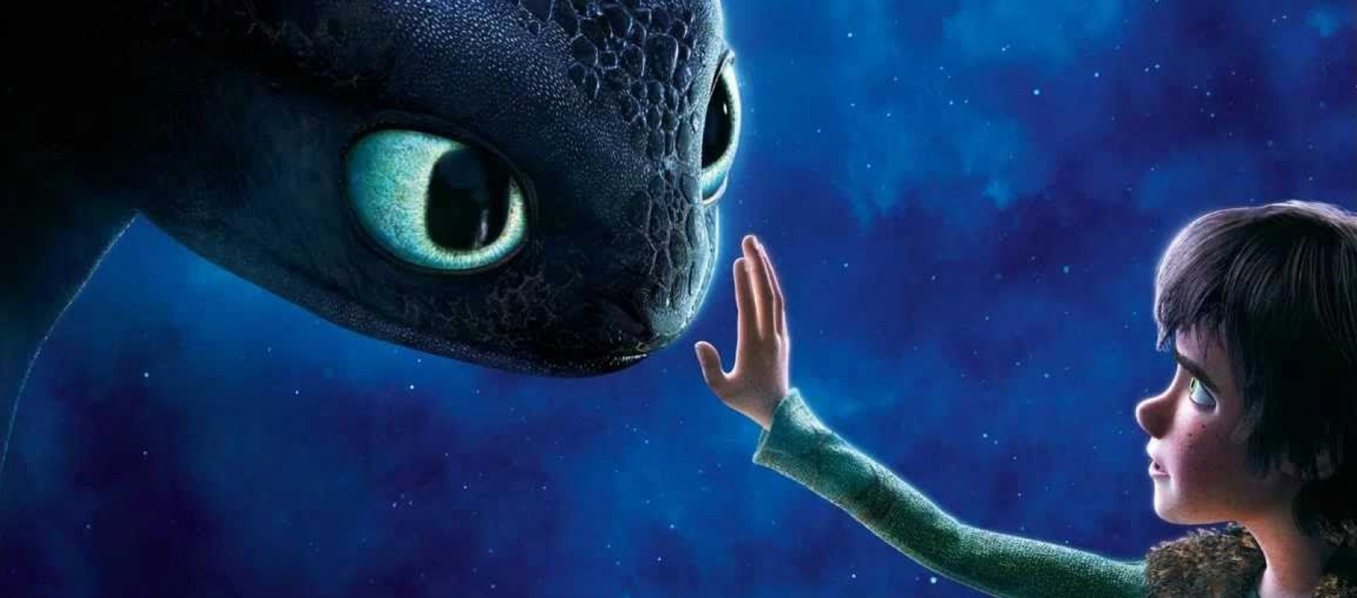 A young cartoon boy is holding up his hand to touch the nose of a large cartoon dragon. The sky behind them is a dark blue and filled with stars. 