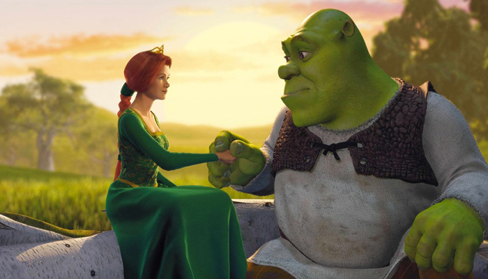 An animated image of a large, green cartoon ogre a human woman wearing a green gown and a crown. They are sitting and holding hands in front of a sunset.