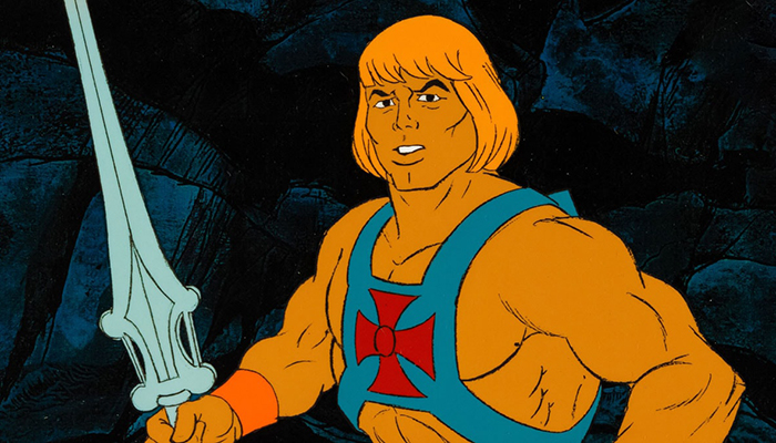 An animated, strong man with furrowed brows, bared teeth, and orange-tinted hair and skin. He holds a sword and wears a vest with a red cross in the middle.