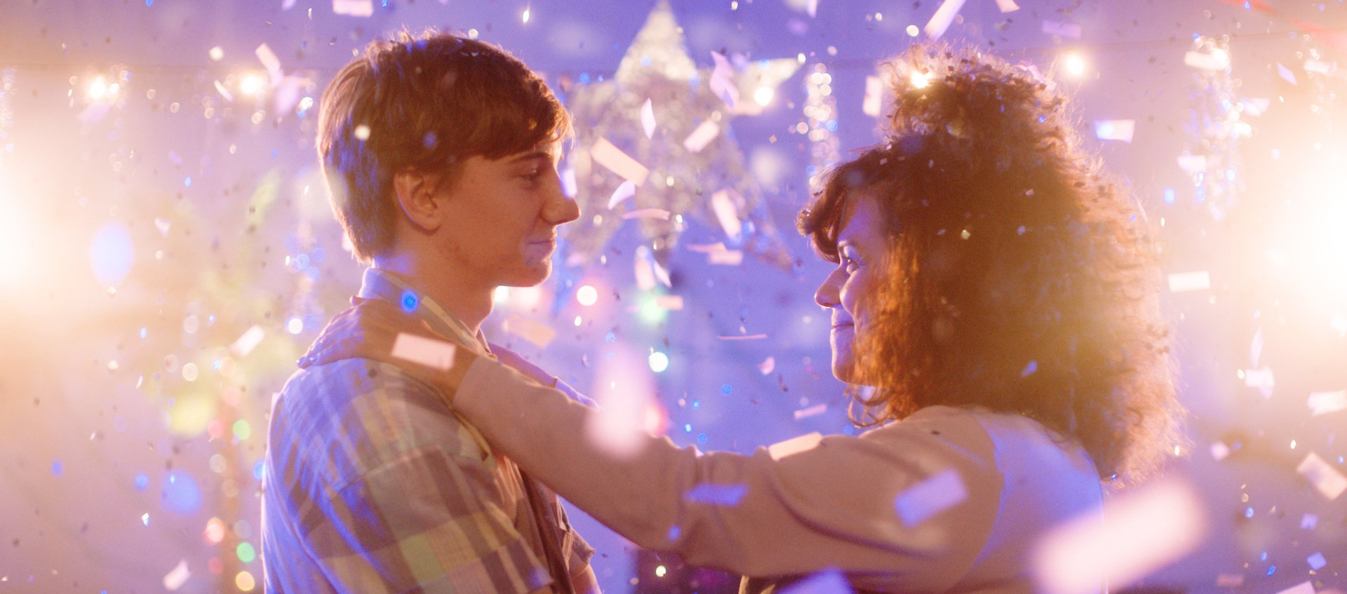 Cecilia Aldorando has her hands on the shoulders of her first boyfriend as they dance together surrounded by confetti. 