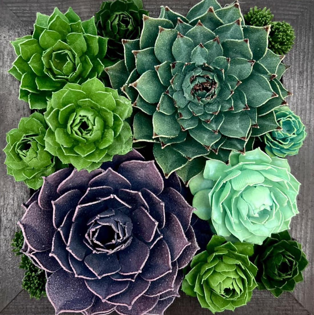 An overhead shot of realistic-looking succulent plants sculpted from paper.