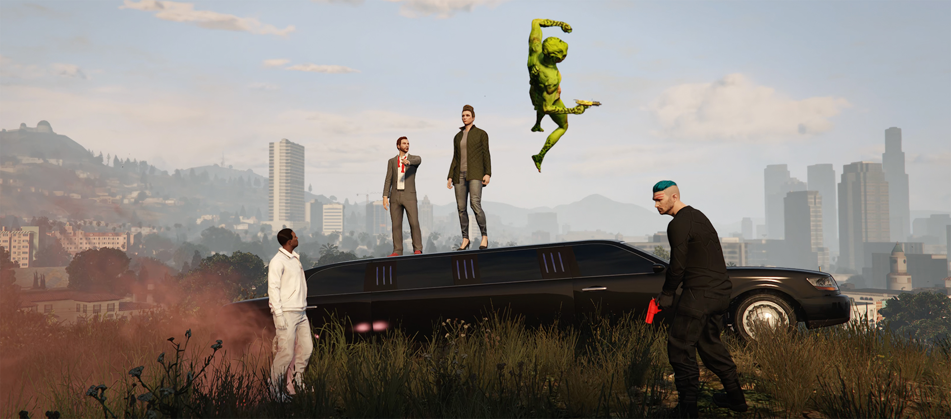 Still from Grand Theft Auto, two characters stand on a limo, an alien is in the air, one man holds a gun.