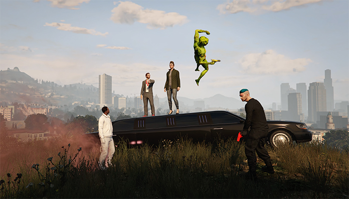 Still from Grand Theft Auto, two characters stand on a limo, an alien is in the air, one man holds a gun.