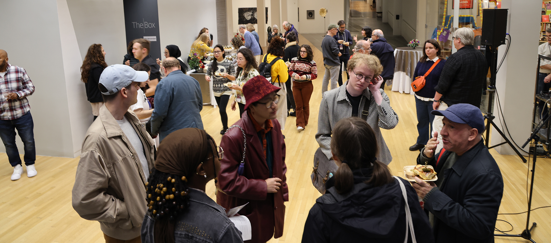 A group of people in the Wexner Center lower lobby.