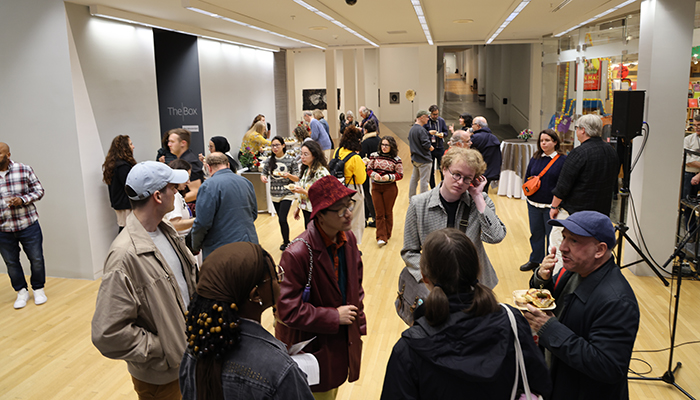 A group of people in the Wexner Center lower lobby.