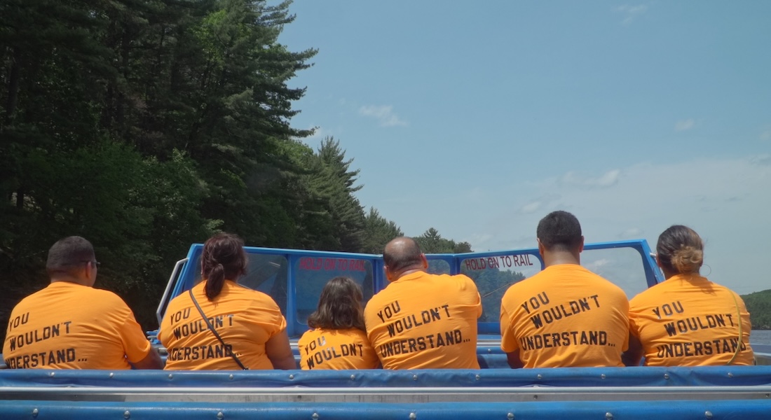 A group of people with their backs to the camera, each wearing a t-shirt that reads "You wouldn't understand."