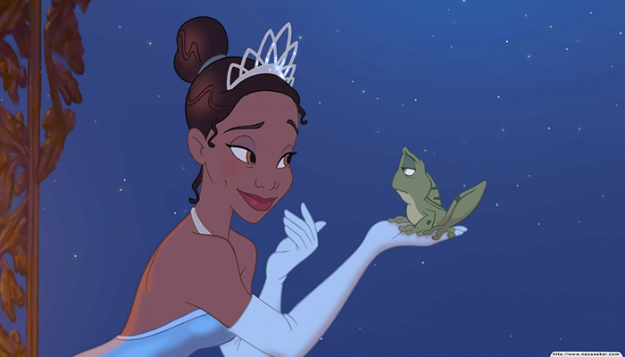 An animated image of Tiana holding a frog and smiling at it. Tiana wears a tiara and gloves. The frog looks unamused.