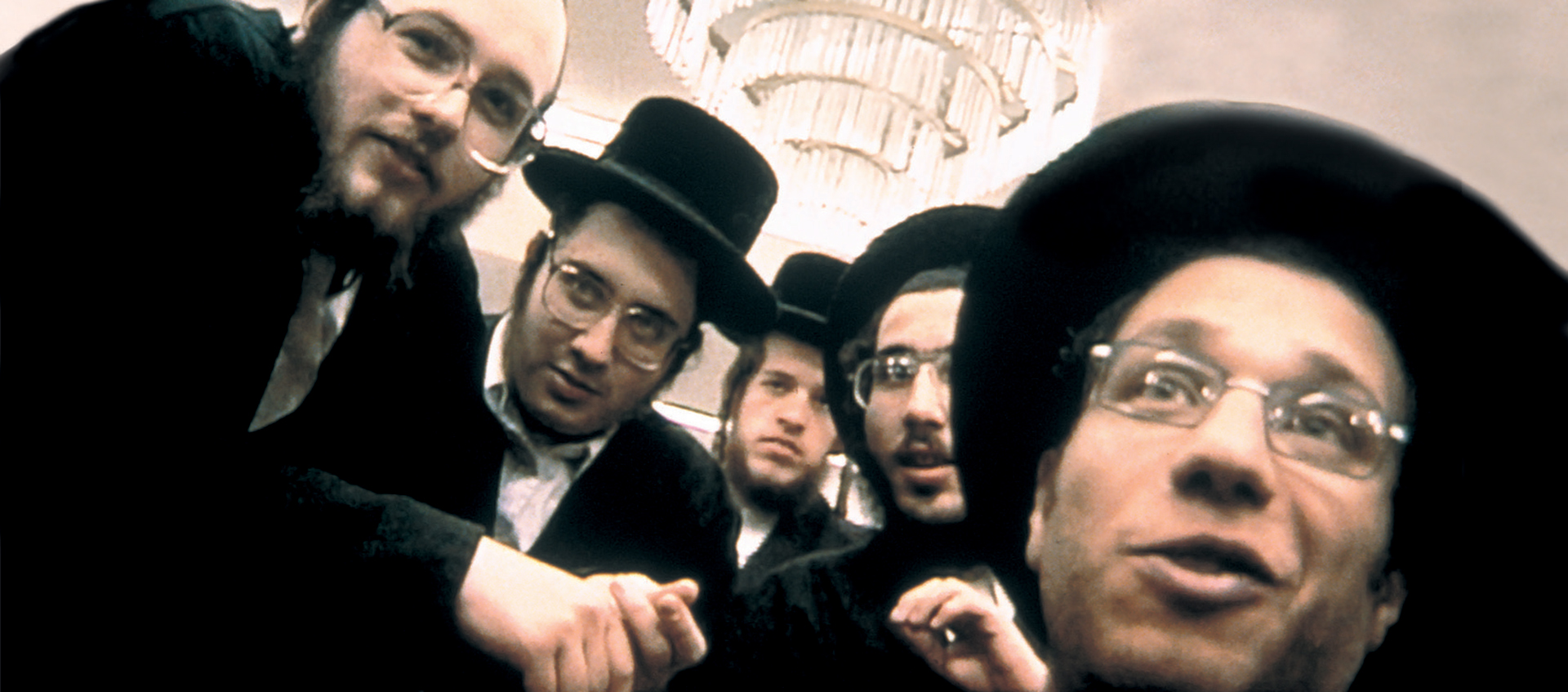 A group of Orthodox Jewish men pose for a picture.