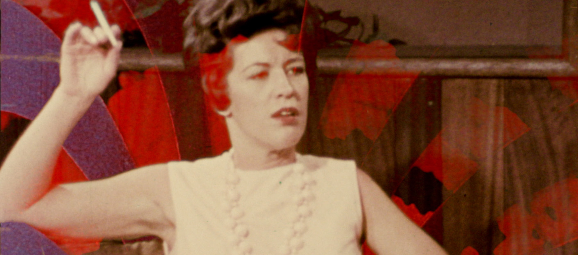 Still of a woman smoking a cigarette. Colors and textures are superimposed over her.