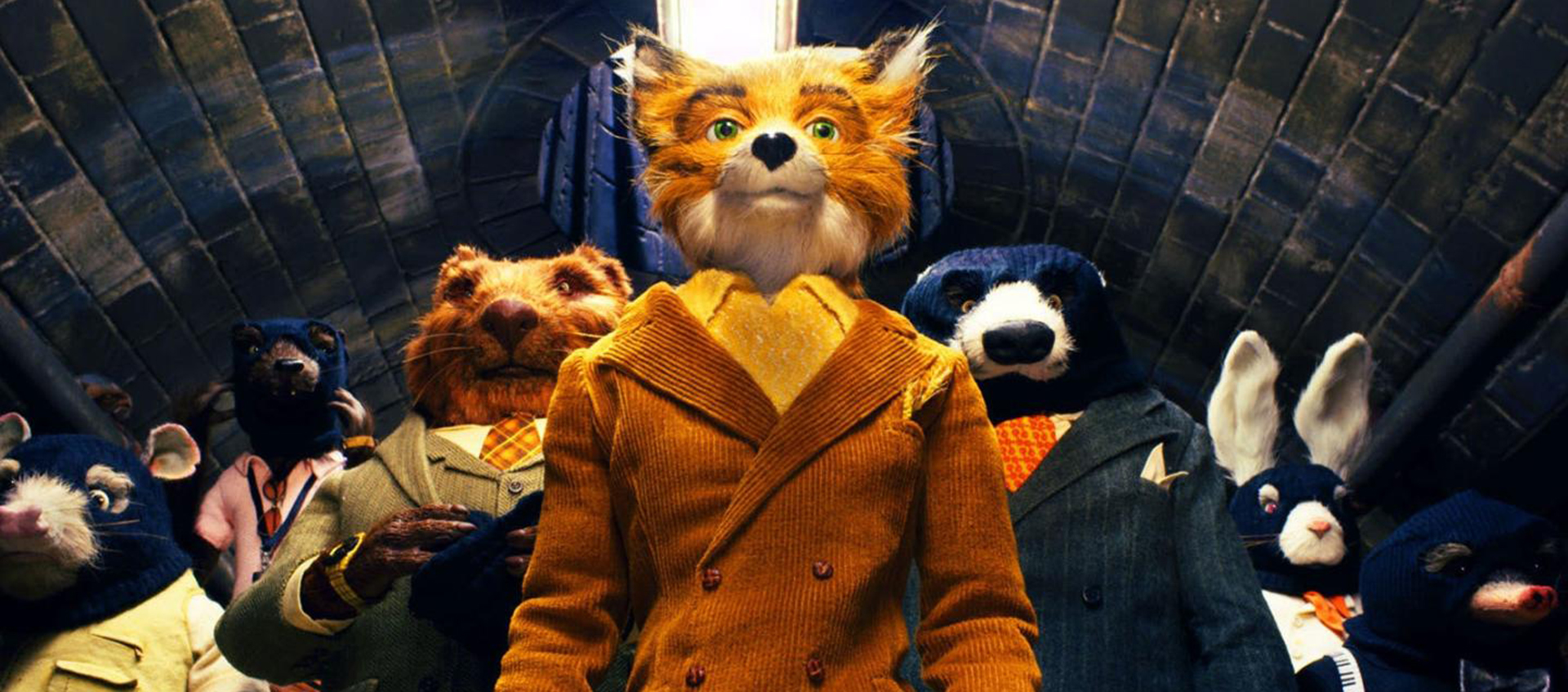 A group of anthropomorphic animals wearing suits stands together in an underground tunnel, with a fox in a yellow coat at the center.