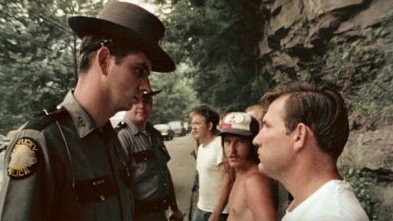 A police officer faces off against a striking coal miner in a scene from Harlan County USA