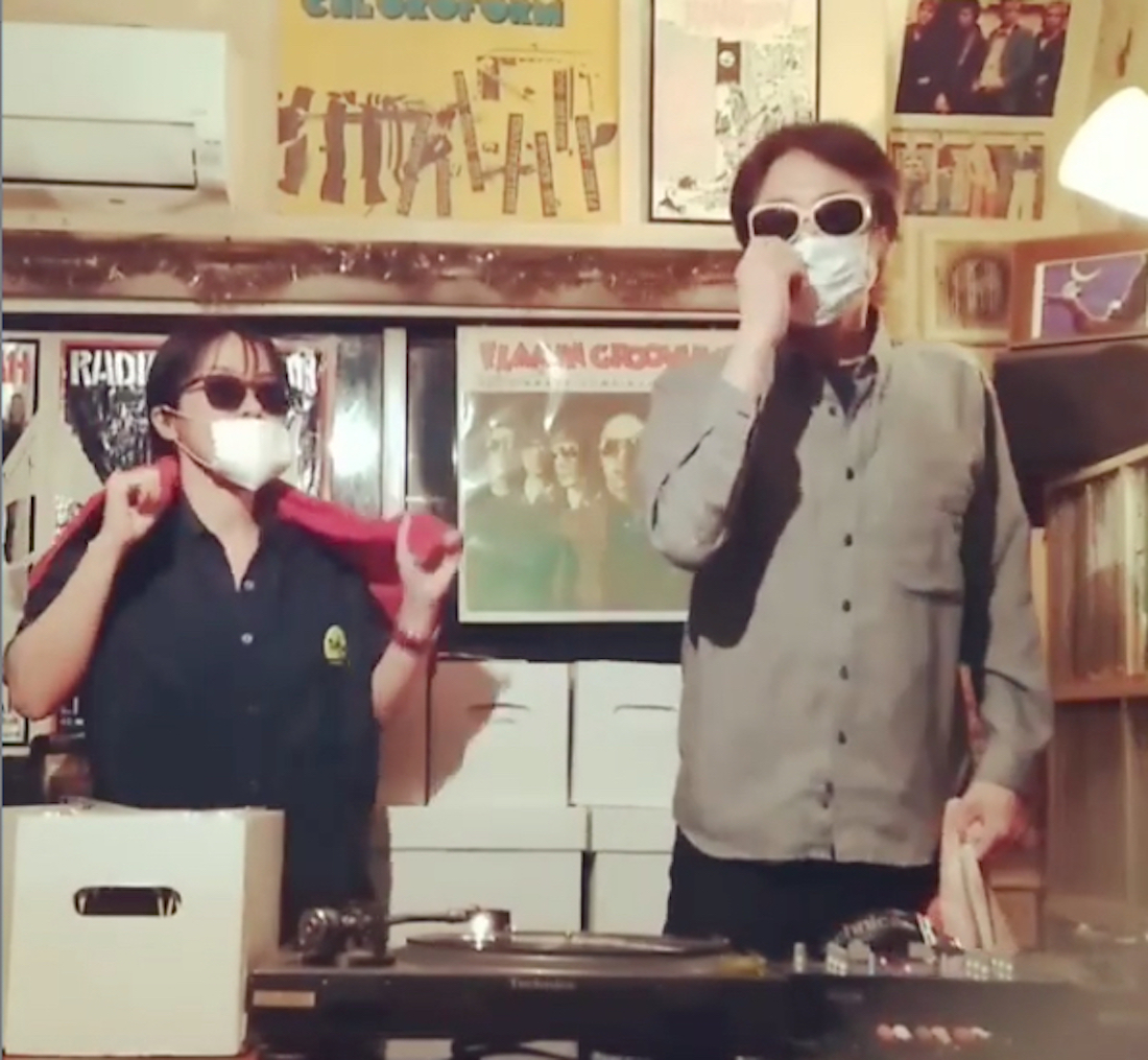 Japanese music artist Fifi wearing a mask with a friend in a space full of records